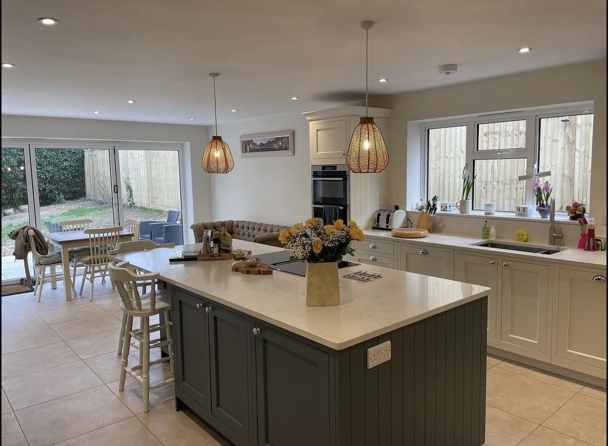 Open plan kitchen diner with sage green island painted by Hamilton Decorating East Sussex