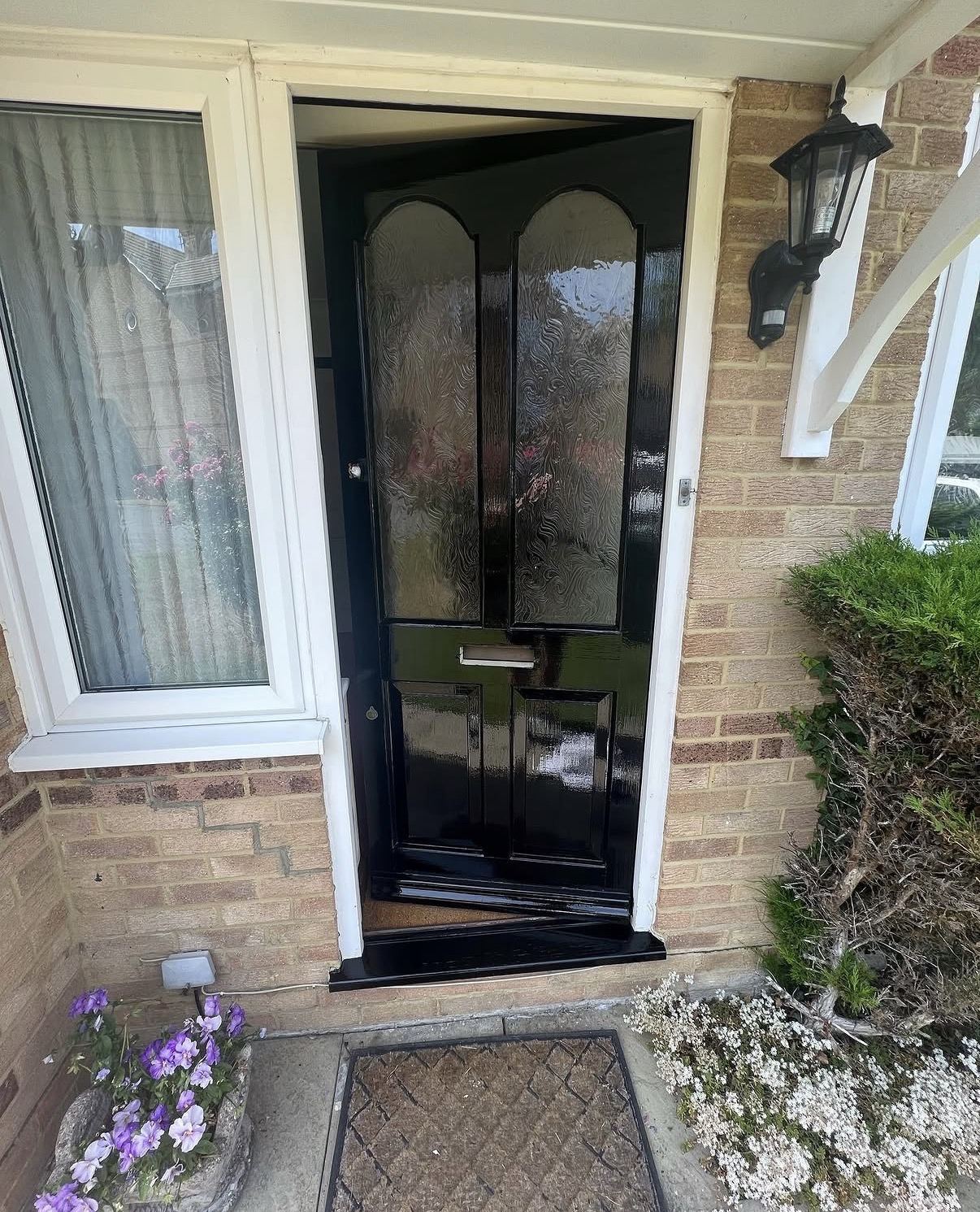 Gloss black front door painted by Hamilton Decorating — exterior painting East Sussex
