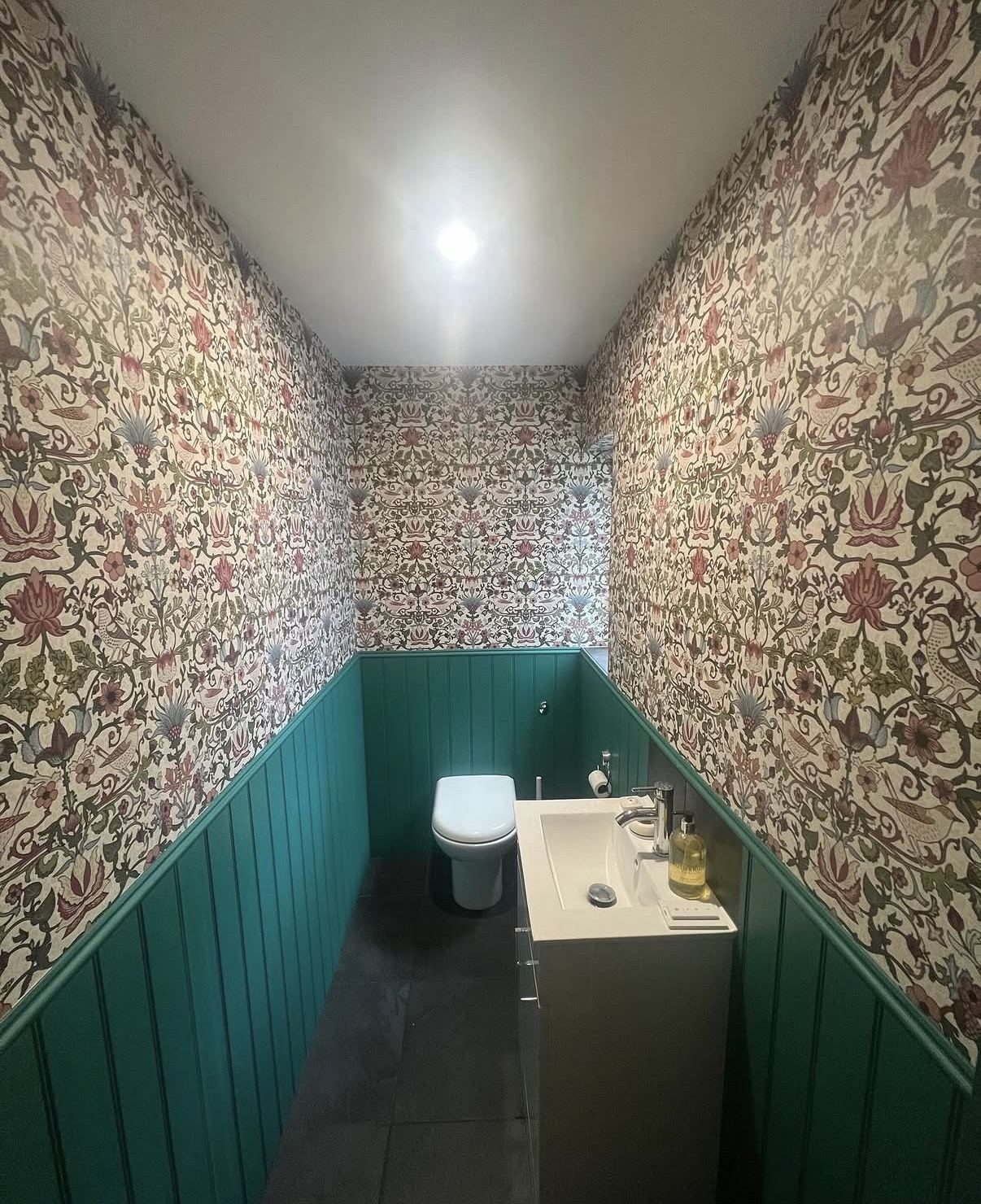 Downstairs cloakroom with Morris and Co wallpaper and teal tongue and groove panelling — Hamilton Decorating